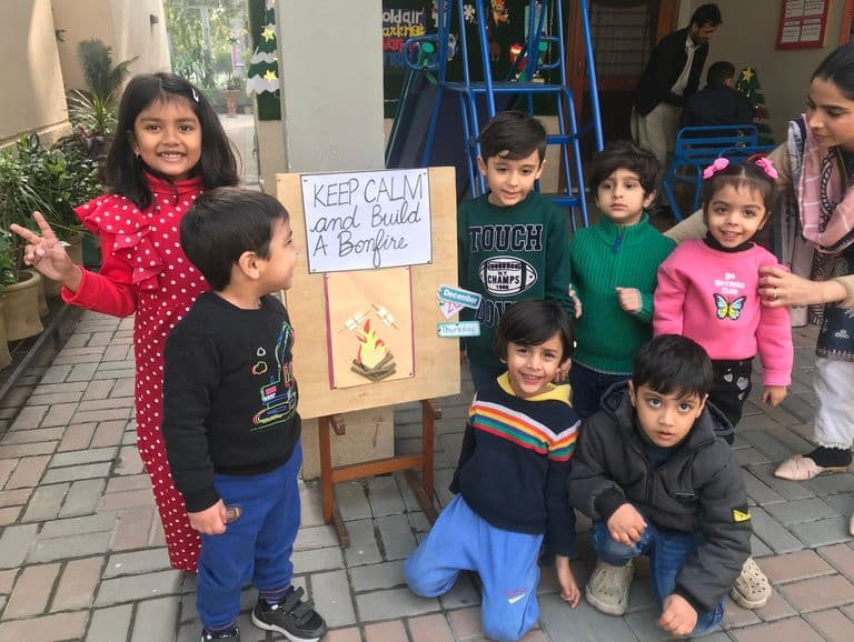Children participating in 4:00 PM outdoor bird feeding activity